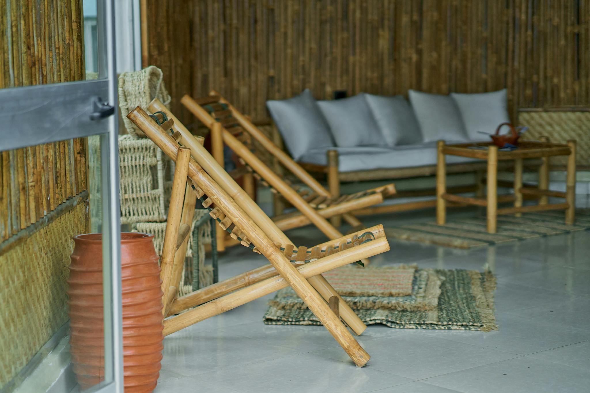 A serene indoor setting featuring bamboo furniture and rustic decor, creating a cozy atmosphere.