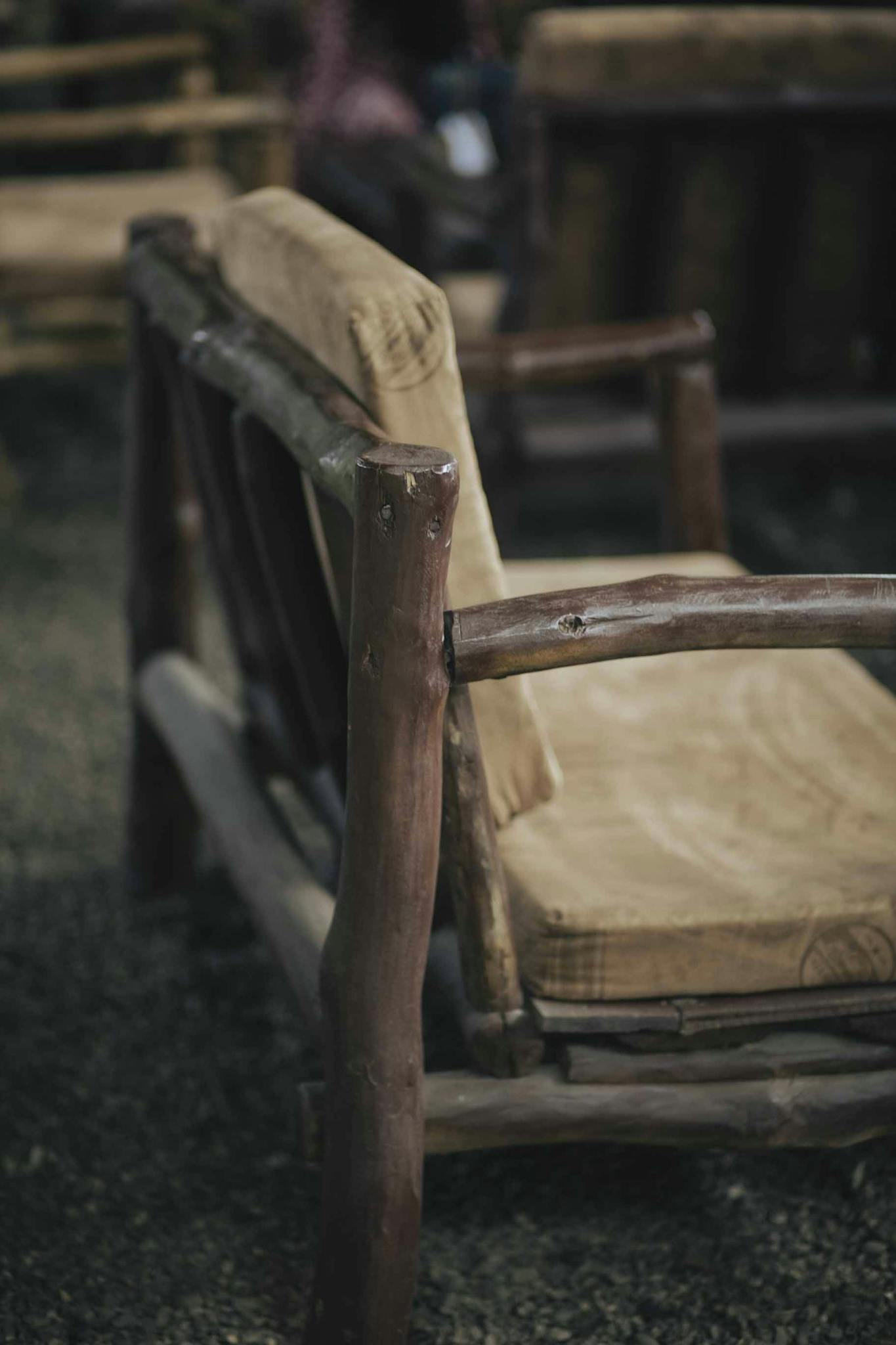 Close-up of a rustic wooden armchair showcasing craftsmanship and natural design.