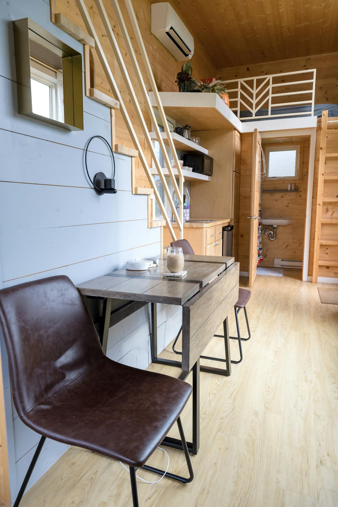 Explore the stylish interior of a modern A-frame cabin with contemporary furniture.
